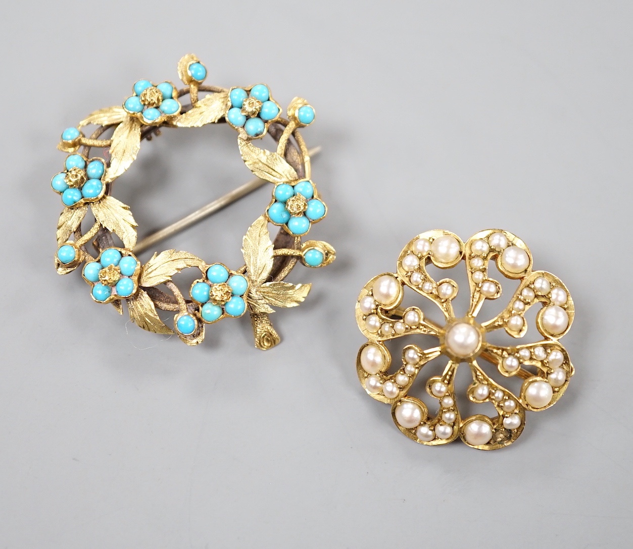 An Edwardian 9ct and seed pearl set brooch, 23mm and a yellow metal and turquoise set wreath brooch, gross 9.3 grams